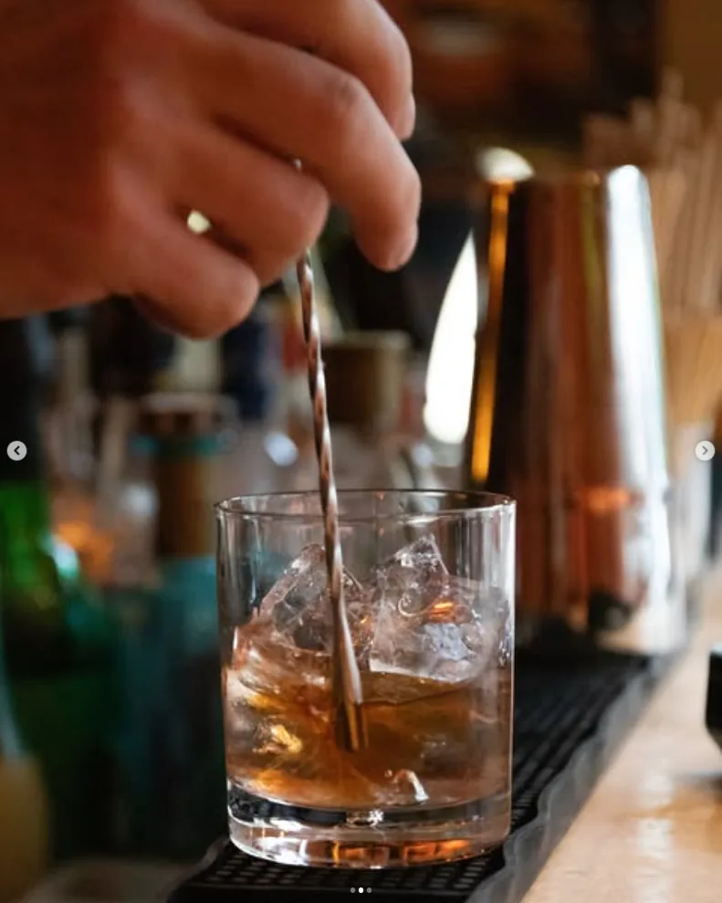 Old Fashioned cocktail being stirred at the bar