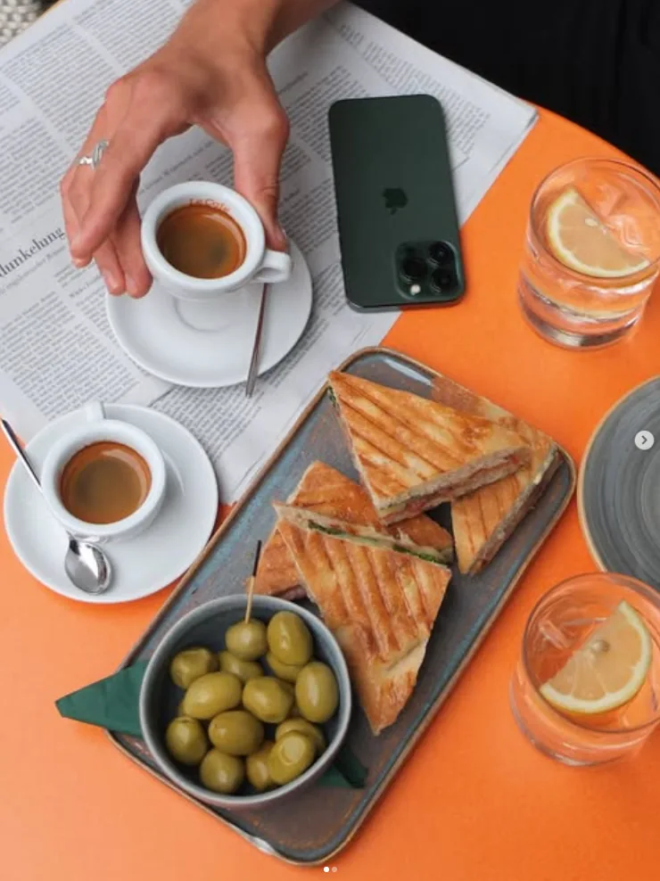 Panini board with olives and espresso