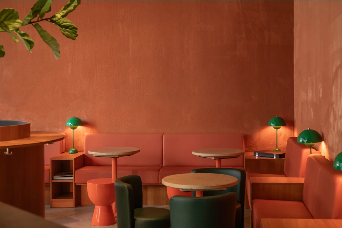 Warm terracotta interior of Le Café Bar