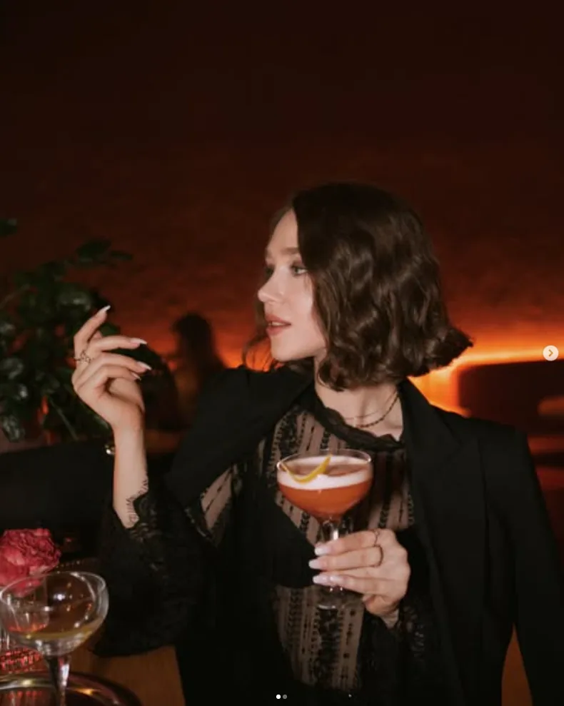 Guest holding a cocktail at night